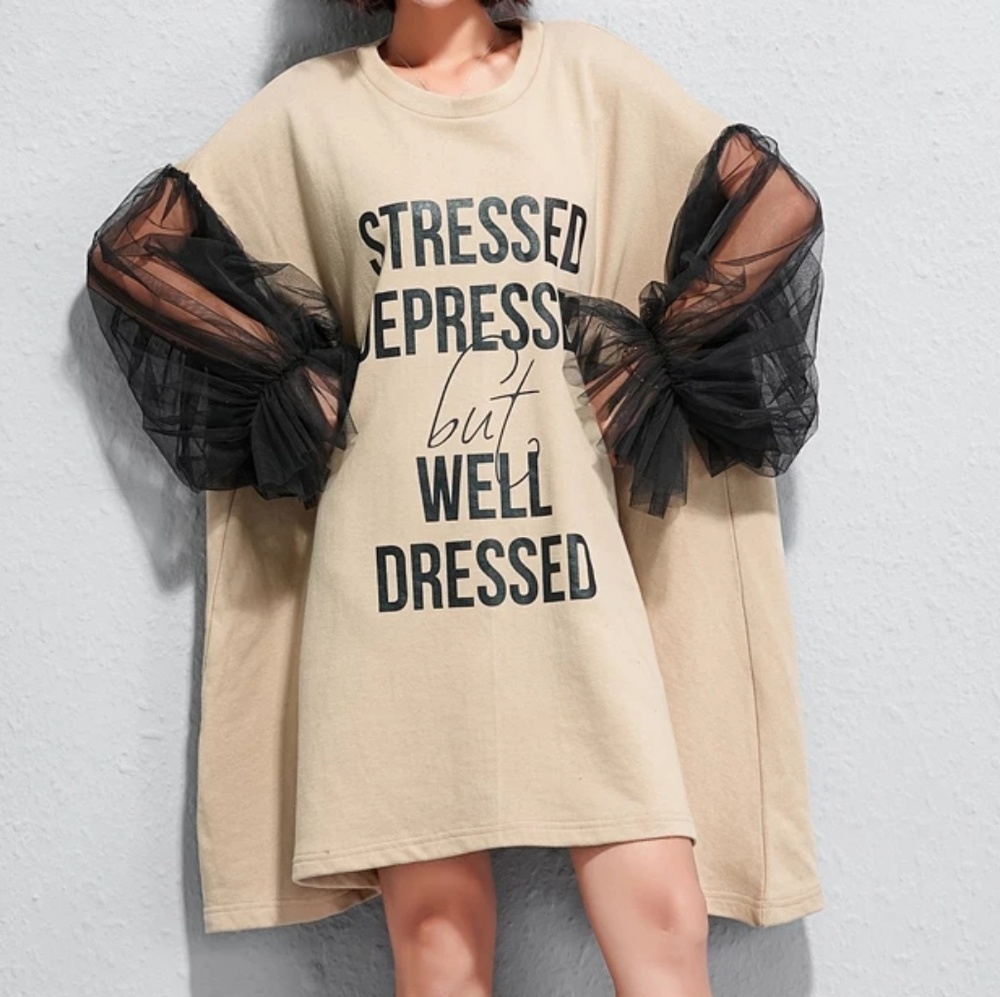 New with tags tan and black dress with sheer sleev